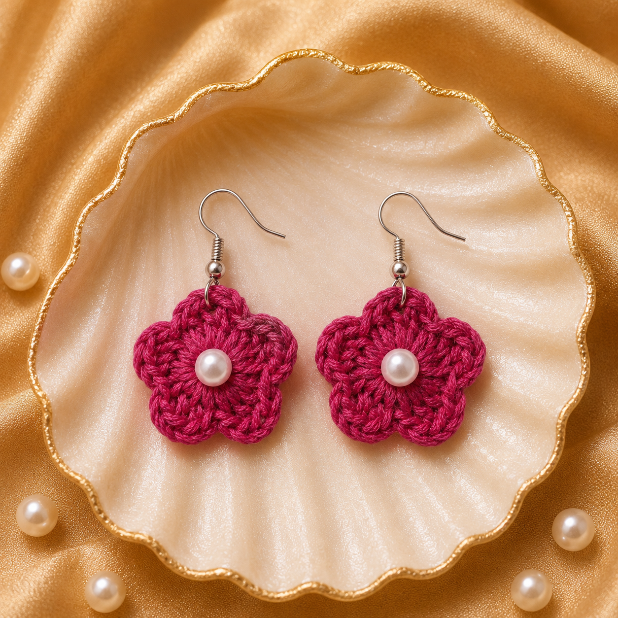 Dark Pink flower-shaped earrings with pearl centers on a shell and pearl background artisian touch