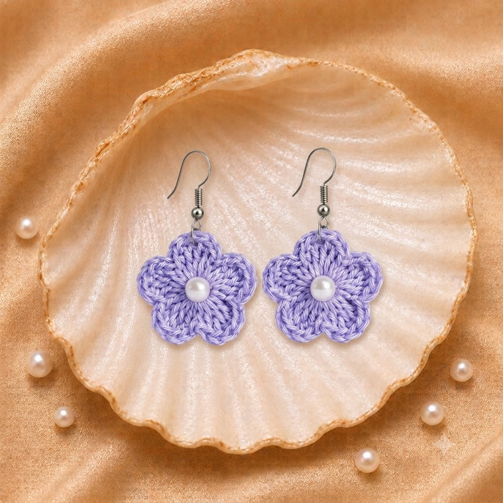 Light Purple flower-shaped earrings with pearls on a seashell and pearl background artisian touch