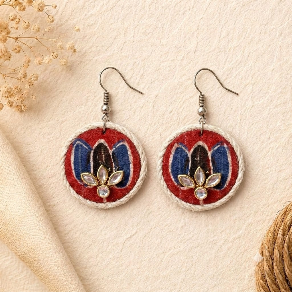 Pair of lotus earrings with floral design on a beige background with kundan