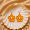 Mustard Yellow flower-shaped earrings with pearls on a shell and pearl background artisian touch