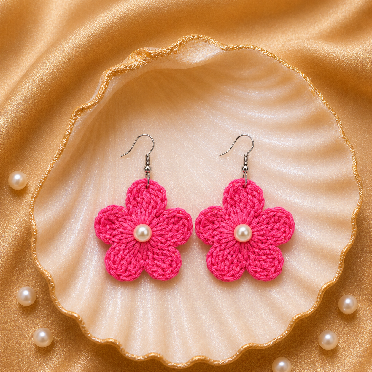 Pink flower-shaped earrings with pearls on a shell and pearl background artisian touch