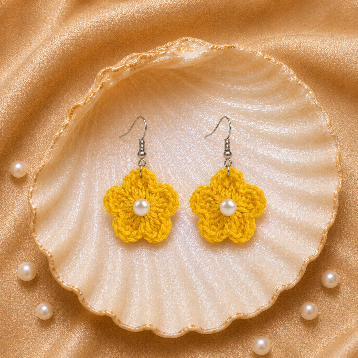 Yellow flower-shaped earrings with pearls on a shell and pearl background artisian touch