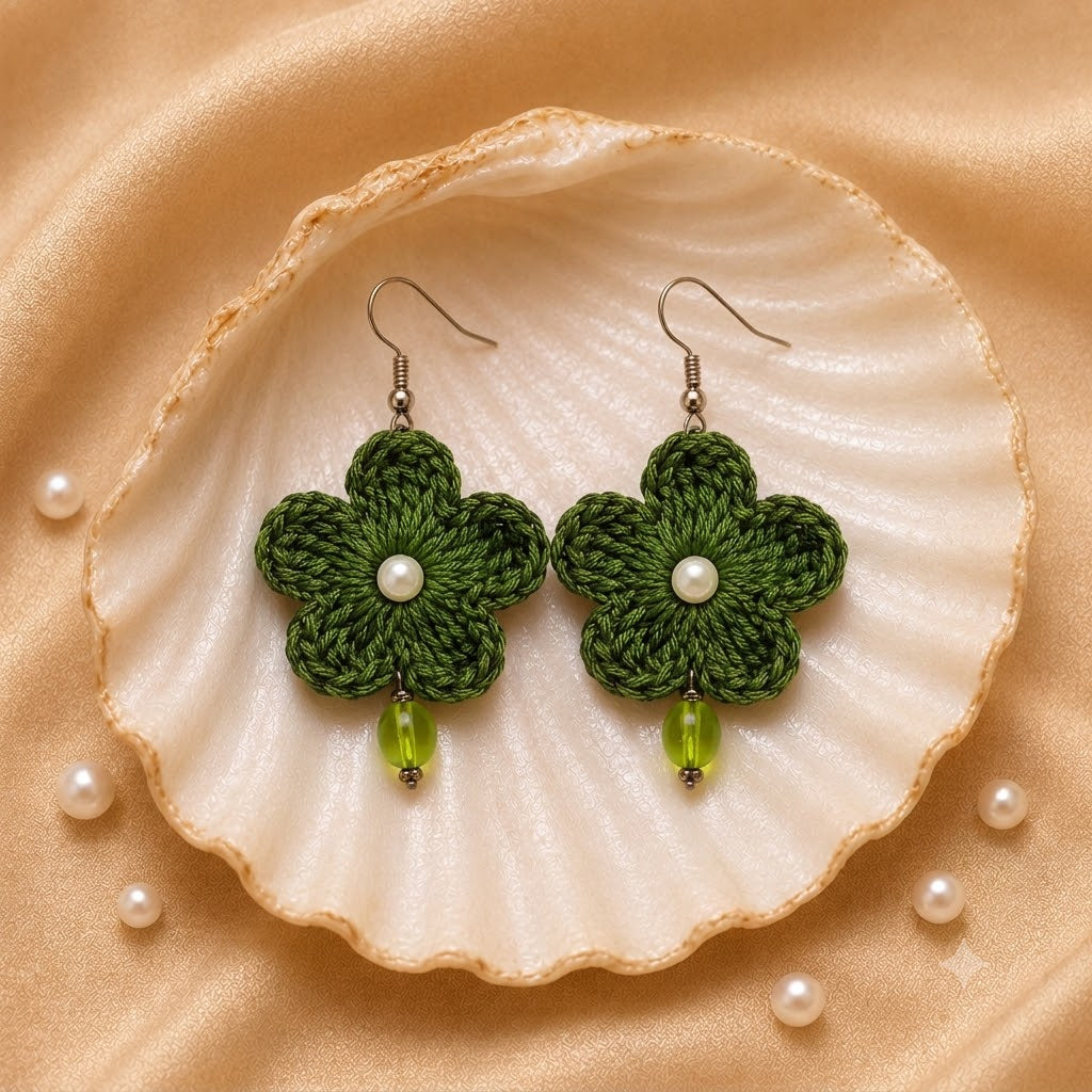Green handmade crochet flower earrings with pearl and green bead accents by Artisian Touch