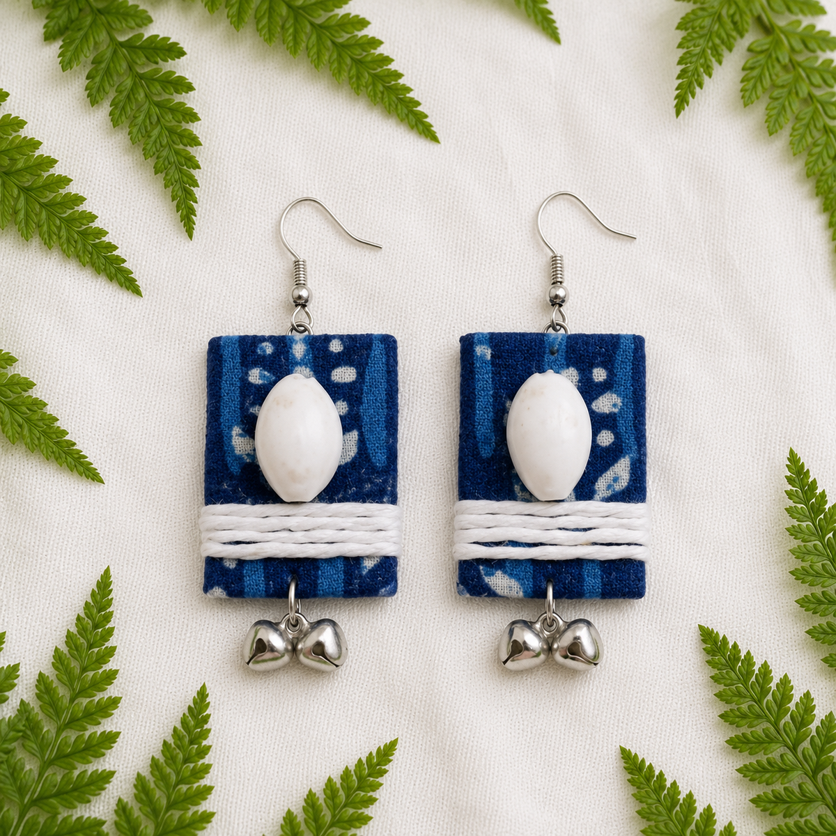 Handmade rectangle Indigo fabric earrings with white jute thread wrapping, cowrie shells, and silver ghungroos by artisian touch