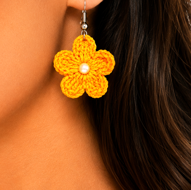 Close-up of a woman wearing a yellow flower-shaped earring artisian touch